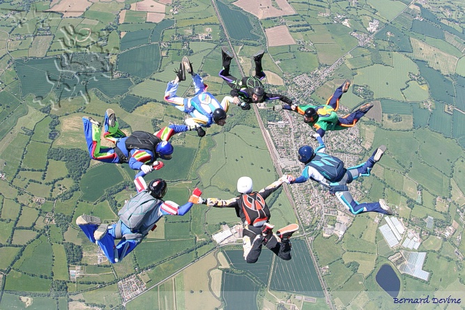 Junior team "2 Balls Short" getting the first point star formation, Headcorn village in the background